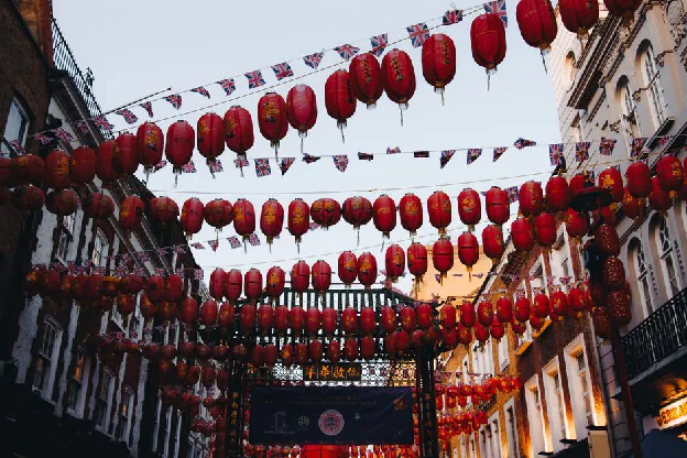 chinese new year factory shutdown - Colorful red lanterns line the streets of Chinatown in London, capturing a vibrant festive atmosphere.