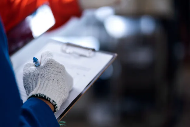 An image that shows a worker preparing a spec sheet