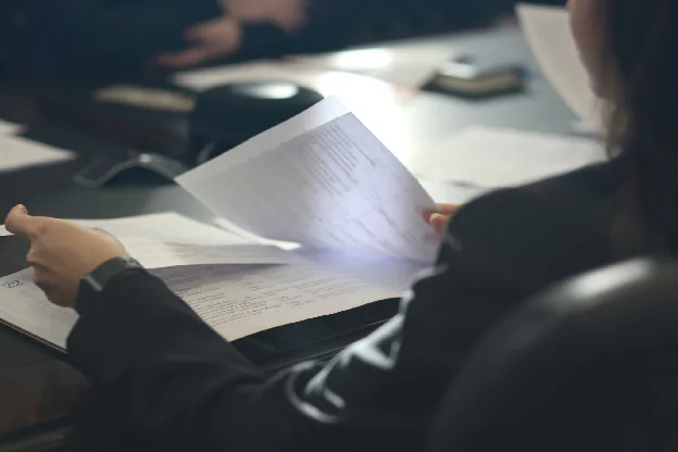 A worker reviewing a spec sheet