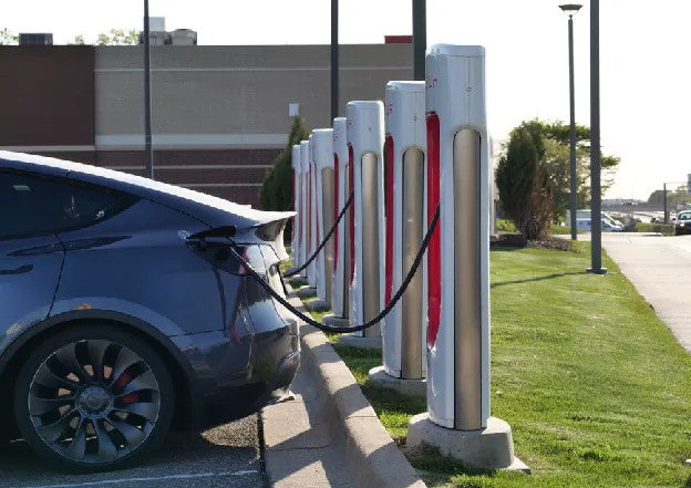 ev charger from china - Electric car plugged into a row of charging stations, showcasing modern EV infrastructure.
